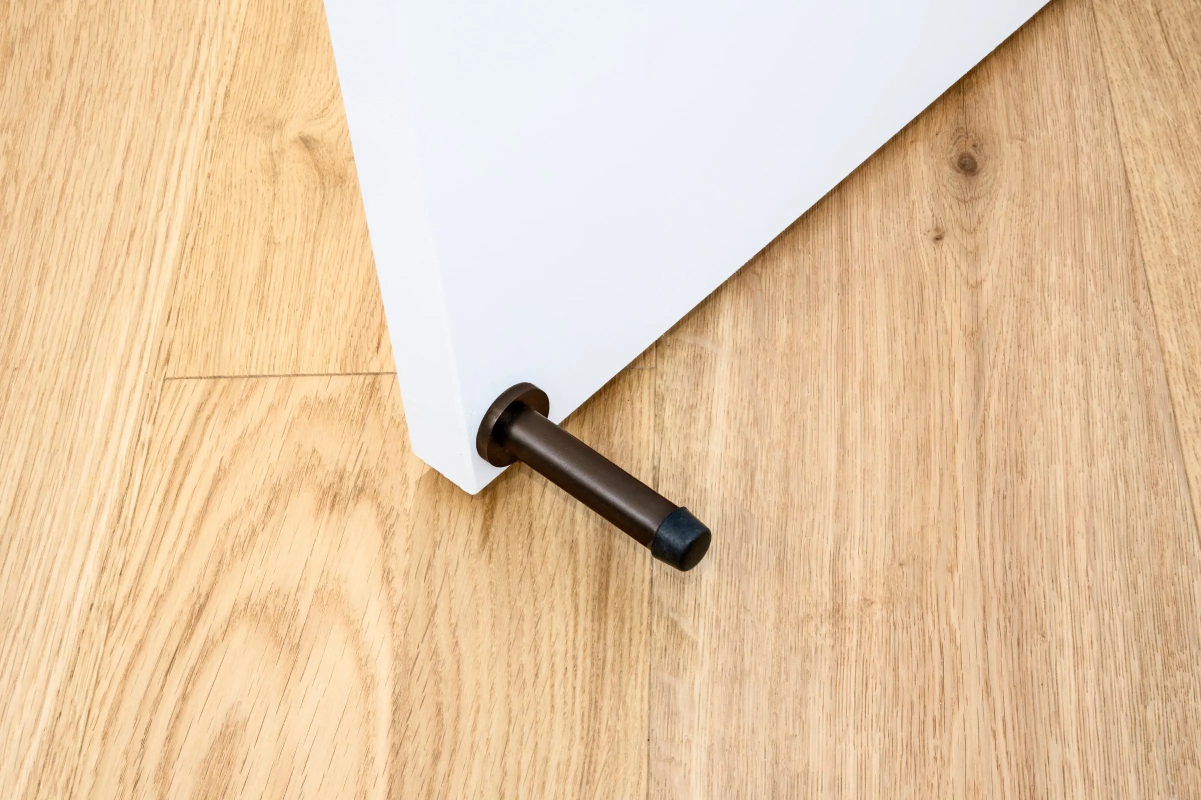 Skirting-mounted door stop, Ember Bronze, Hume Doors & Timber and Zanda range supplied by Integrity