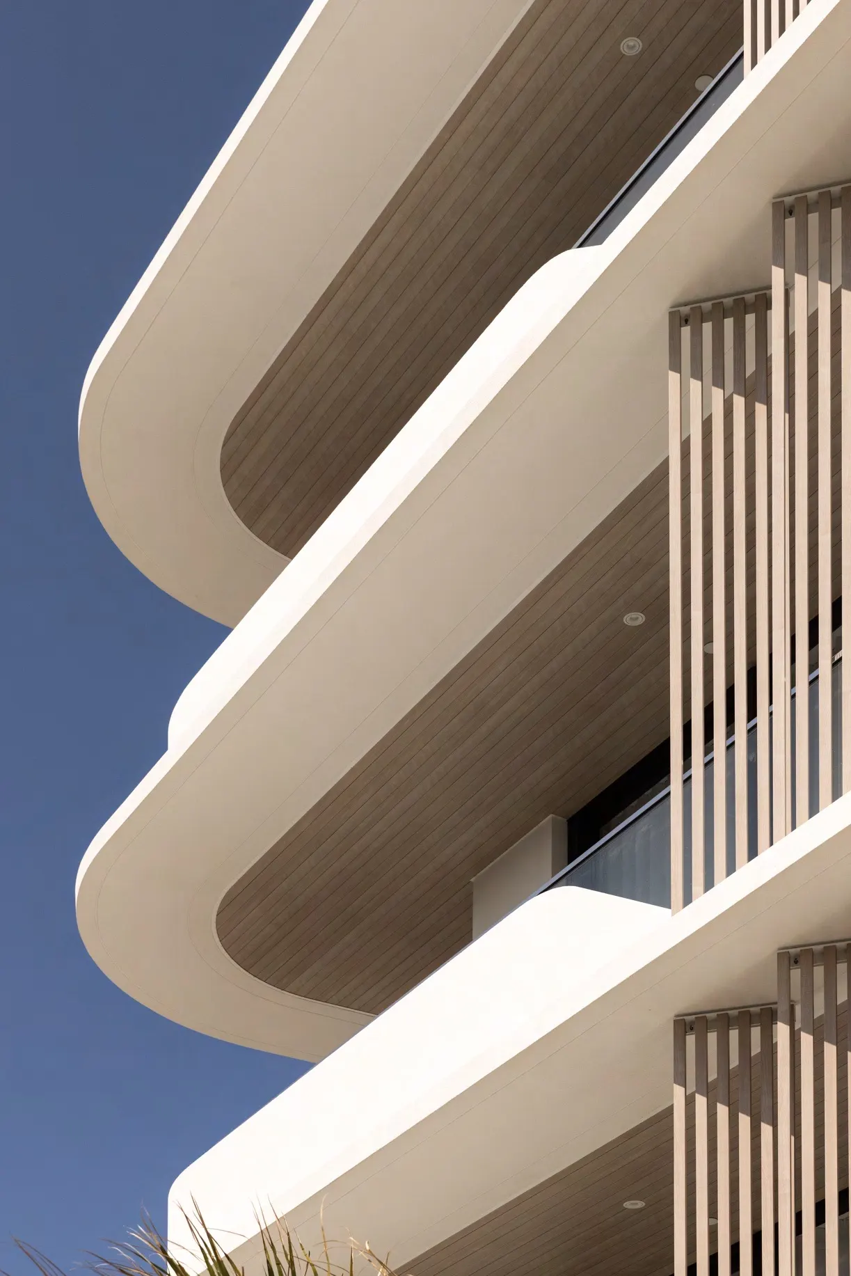 Timber-look aluminium soffit lining and vertical battens on apartment balconies
